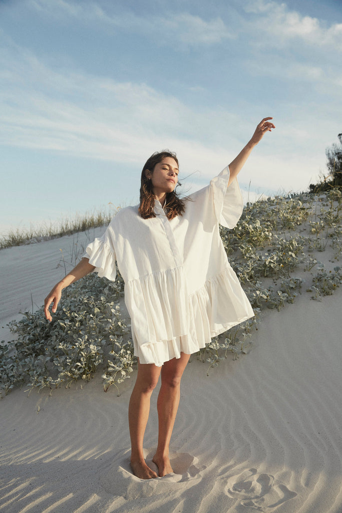woman in white flowy cotton dress cape town beach scene